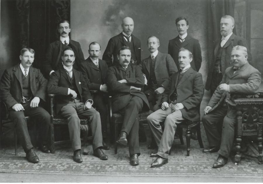 Henry Vivian (seated centre), Harry C. Perry (left of and slightly behind Vivian), Hubert Brampton (front row, right of Vivian), William Hutchings (seated 2nd from left), Fred Watts (seated far right), Fred Litchfield (standing far right).